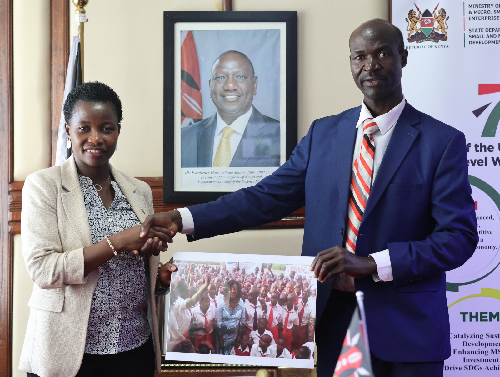 Principal Secretary Hon. Susan Mang'eni handshakes Dr. Tom Mboya Owino