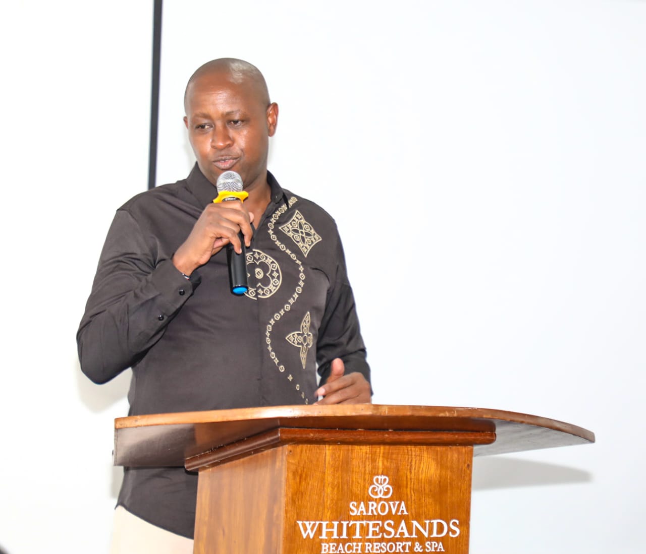 Principal Secretary Patrick Kilemi delivers speach at the Induction Retreat