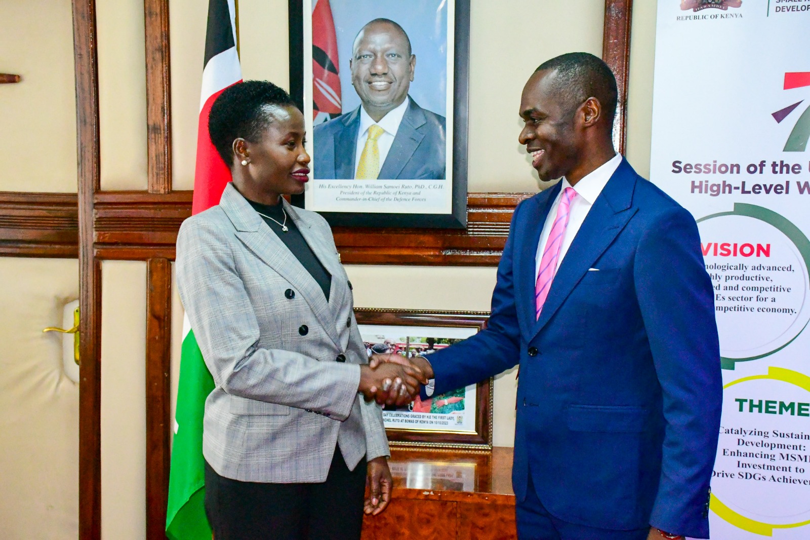 Hon. Susan Mang'eni handshakes Dr. Bernard Chitunga, Ph.D from Asian Infrastructure Investment Bank