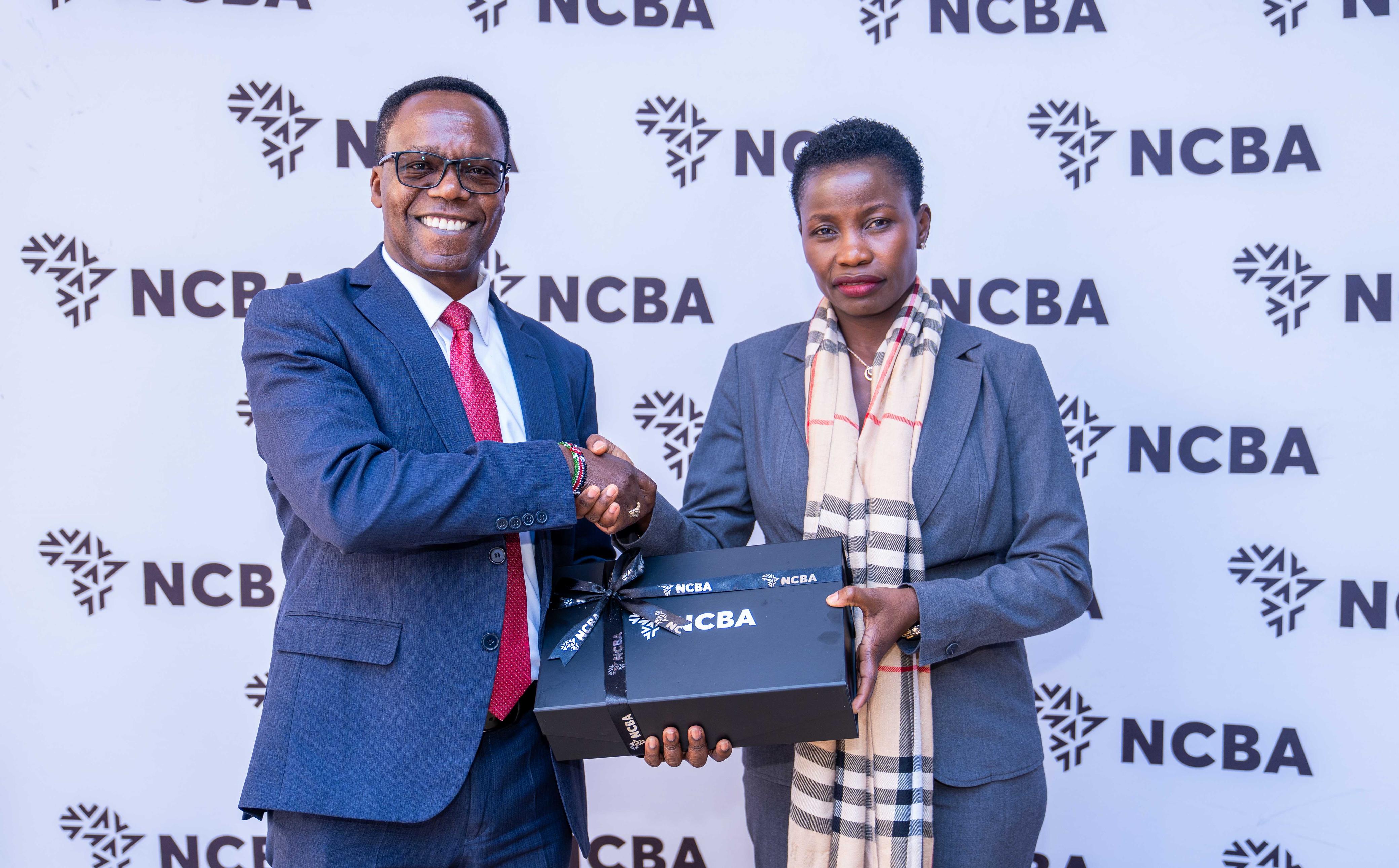 Hon. Susan Mangeni is handed a gift box at the NCBA forum