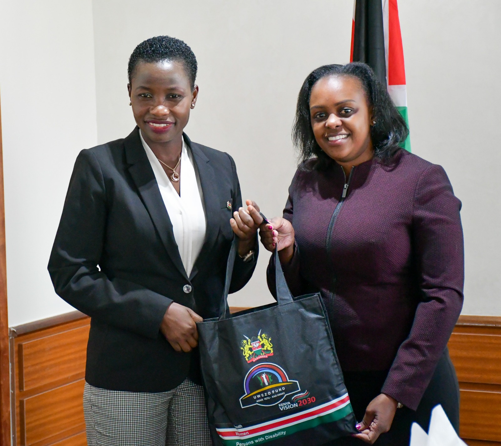 PS.  MSME Hon. Mang'eni receives a gift basket from Uwezo Fund board chairperson