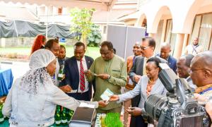 SMEs showcase their products as they hand out brochures to CS. Hon. Wycliffe Oparanya among other delegates