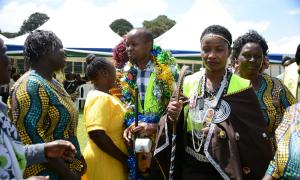 Hon. Mang'eni adorned with cultural with cultural artifacts at the event