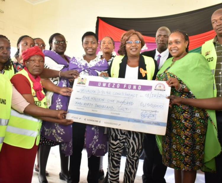 PS. Hon. Susan Mangeni issuing Uwezo Fund cheques at Nakuru